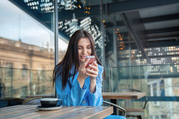 happy young girl looking at phone with smile