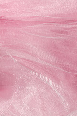 Pink tulle fabric texture top view. Coral background. Fashion color trends feminine tutu skirt flat...