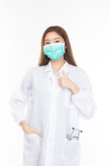 Beautiful portrait friendly asian female doctor or nurse in medical mask showing thumbs up at medical clinic isolated on white background. Mask to prevent virus concept.