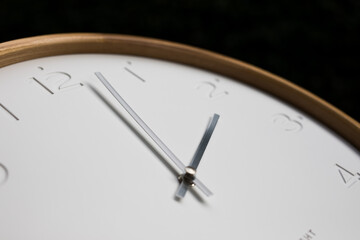 Simple modern clock with white face and silver arms 