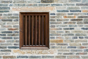 Retro wooden grid windows on masonry wall