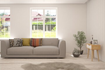 Obraz premium White living room with sofa and summer landscape in window. Scandinavian interior design. 3D illustration