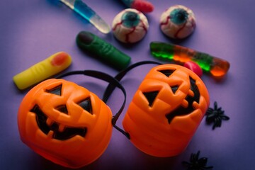 halloween candies seen close up on yellow background