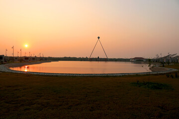  view Statue of Mahatma Gandhi with lake during sunset at the National Salt Satyagraha Memorial