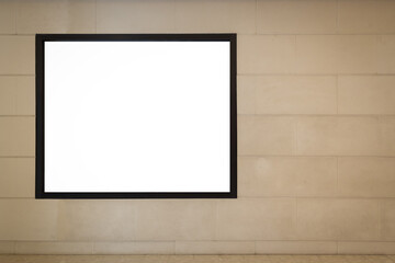 Blank white advertising billboard on the wall with a black frame inside a department store in the city, mockup ad sign.