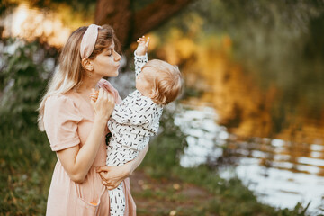 A mother holds her son in her arms on a summer day