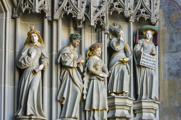 sculptures representing the foolish virgins on the tympanum of the cathedral, in Bern, Switzerland
