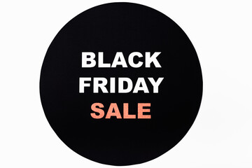Top view of black friday sale lettering on black circle on white background
