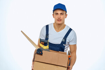 A man in a working uniform with a box in his hand loading a delivery service
