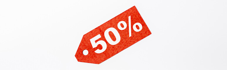 Panoramic crop of red price tag with 50 percent signs on white background