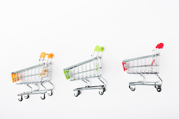 Top view of small shopping carts on white background