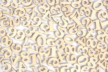 Wooden numbers from zero to nine on a white background, abstract background.
