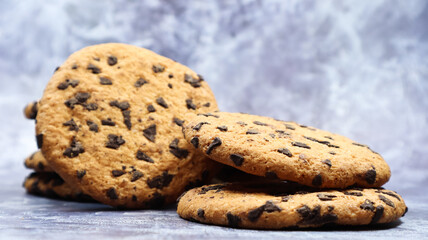 Soft, freshly baked chocolate chip cookies on a gray marble kitchen countertop. American traditional sweet pastry pastry, delicious homemade dessert. Culinary background.