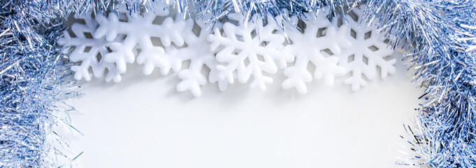 Happy New Year banner, decorative snowflakes lying on a silver sparkling background. Horizontal Christmas posters, greeting cards, headers, website