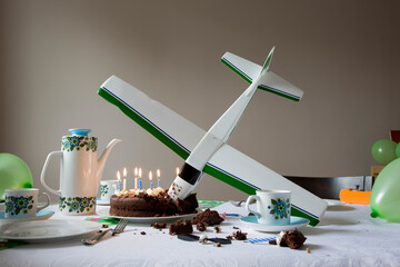 View of a airplane model flown into birthday cake