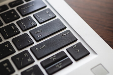 Obraz premium Close up of black computer keyboard in enter and pause key. Selective focus
