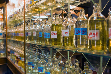 Bottles of essential oils used in perfume making displayed in a row