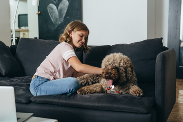 girl playing with her dog at home