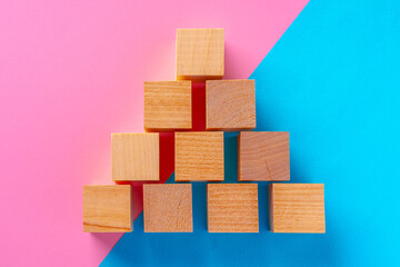 Top view photo of wooden blocks on pink and blue
