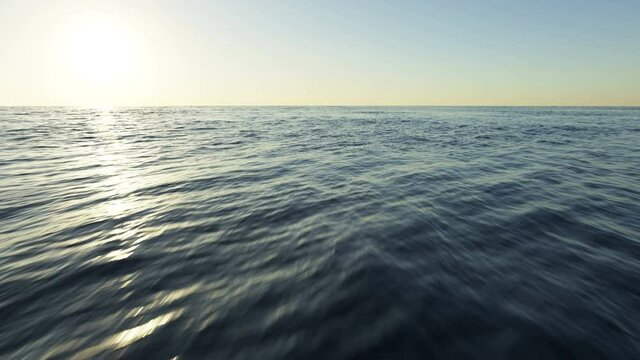 Flying low over an ocean, sea or water as the sun sets on the horizon 3D animation.