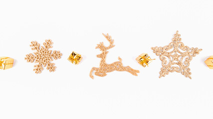 Fototapeta na wymiar Christmas background of golden star and golden reindeer decorations on white background, top view