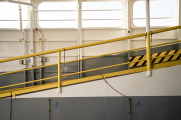 Yellow hand rail on ferry boat ramp
