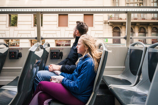 Young Girl and Father Riding in Open Double-Decker Bus in Barcelona