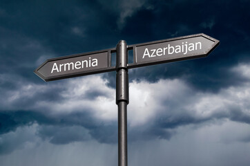 Road sign with the inscription Armenia, Azerbaijan on the background of a stormy sky