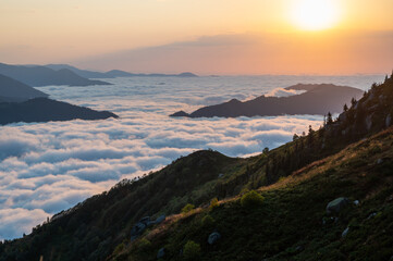 Scenic view from the Huser highlands - clouds drifting among mountains at sunset time