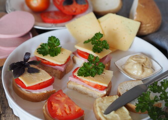 Fresh sandwich with cheese and sausage. Hot sandwiches.Sandwiches with sausage and hard cheese on a wooden background.