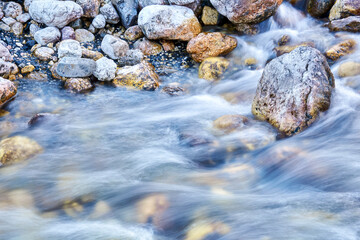 natural blurred background - fast flow of water in a mountain river