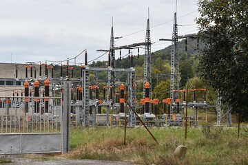 Power transformer station in  district town  Zarnovica, Slovakia Europe, surrounded by a metal fence with massive gate. It supplies the whole region with electricity and is located  industrial zone.