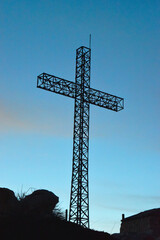 the big metallic christian cross against the light at dusk at the top of the Mountain in Faraya, Lebanon