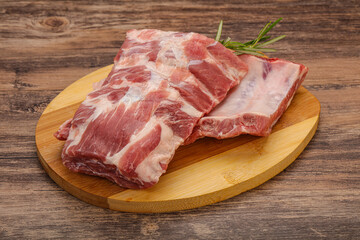 Raw pork ribs served rosemary