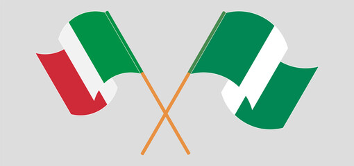 Crossed and waving flags of Nigeria and Italy