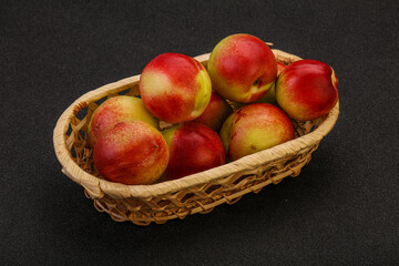 Sweet small nectarines in the basket
