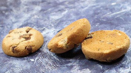 Soft, freshly baked chocolate chip cookies on a gray marble kitchen countertop. American traditional sweet pastry pastry, delicious homemade dessert. Culinary background.