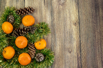 Christmas mood with tangerines and christmas decoration isolated on the wood background