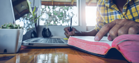 Close up finger reading bible, studying the Bible, Online church in home, Home church during...