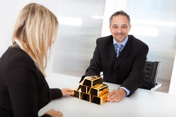Businessman receiving gold bars