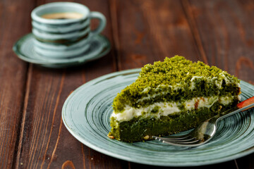 Piece of green spinach cake on plate