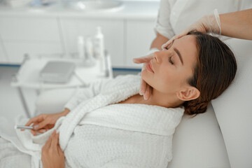 Beautiful healthy smiling caucasian woman is doing beauty procedures at spa and healthcare salon