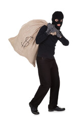 Thief carrying a large bag of money