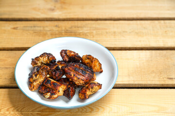 Grilled chicken in pad thai sauce on a light plate.