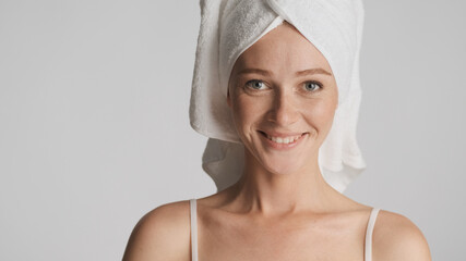 Portrait of girl with smooth healthy skin and towel on head happ