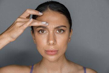 Fototapeta premium Beautiful healthy smiling caucasian woman is doing beauty procedures at spa and healthcare salon