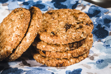 Homemade oatmeal cookies on a blue napkin. Healthy Food Snack Concept