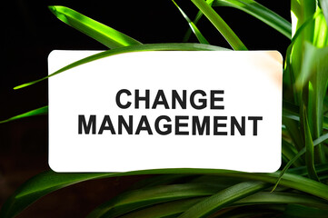 Change management text on white surrounded by green leaves