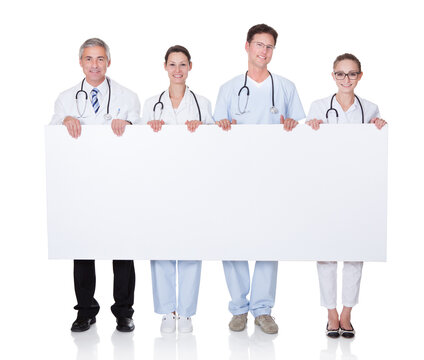 Medical staff holding up a white banner - Powered by Adobe
