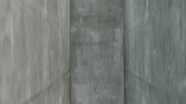 The view from inside a newly built concrete elevator shaft as it lifts from the ground up.